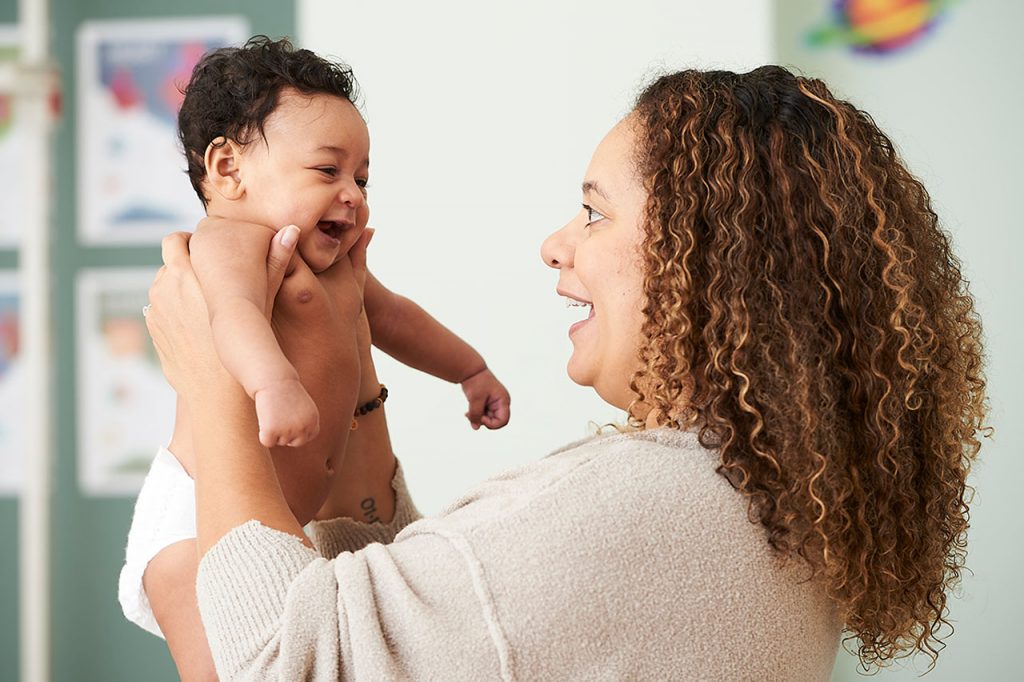 woman holding smiling baby