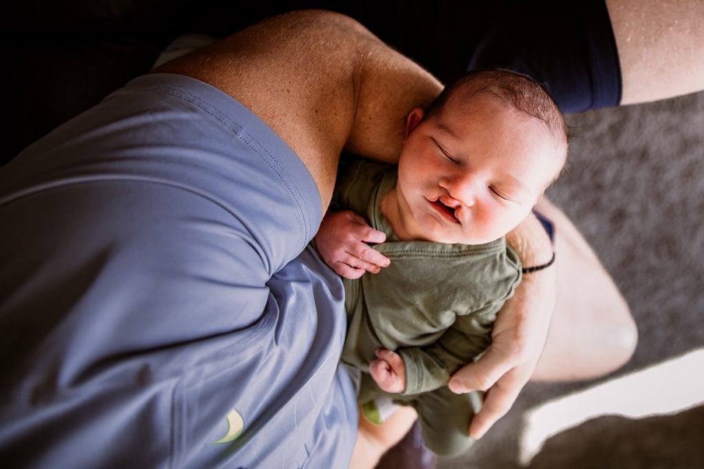 Adam Bighill holding his son Beau.