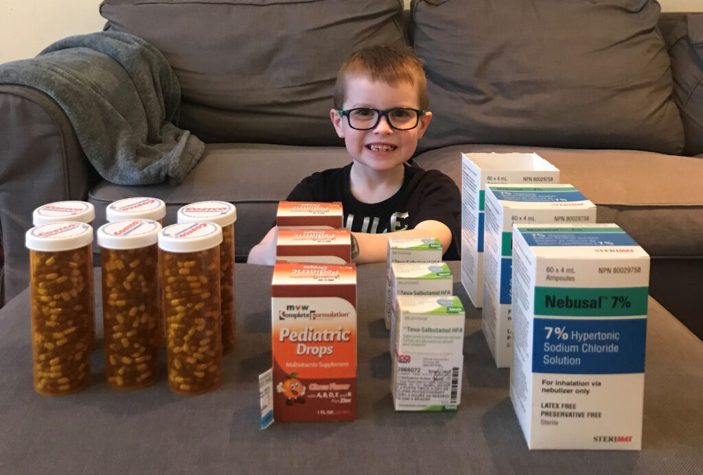 Jack sitting at a table with all his medication.