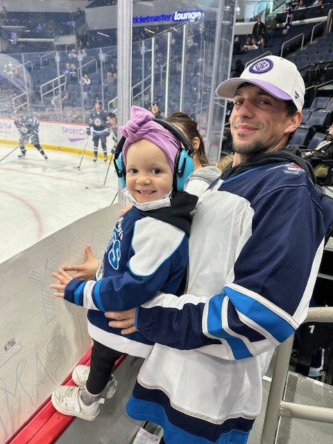 Ella and her dad both in Jets jerseys.