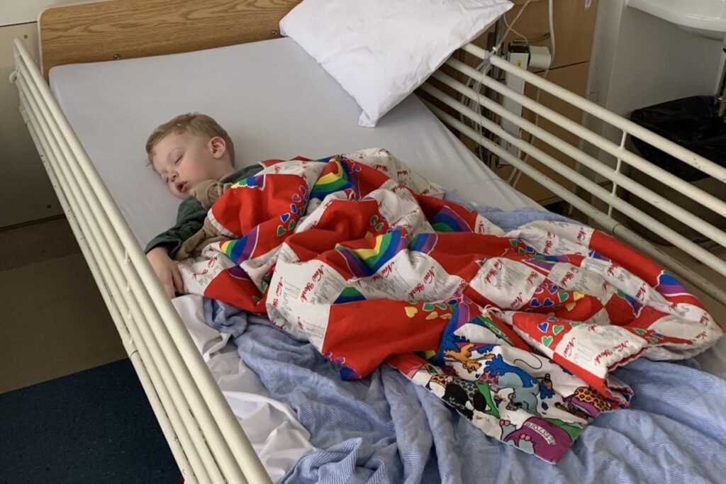 Calvin asleep in his hospital bed.