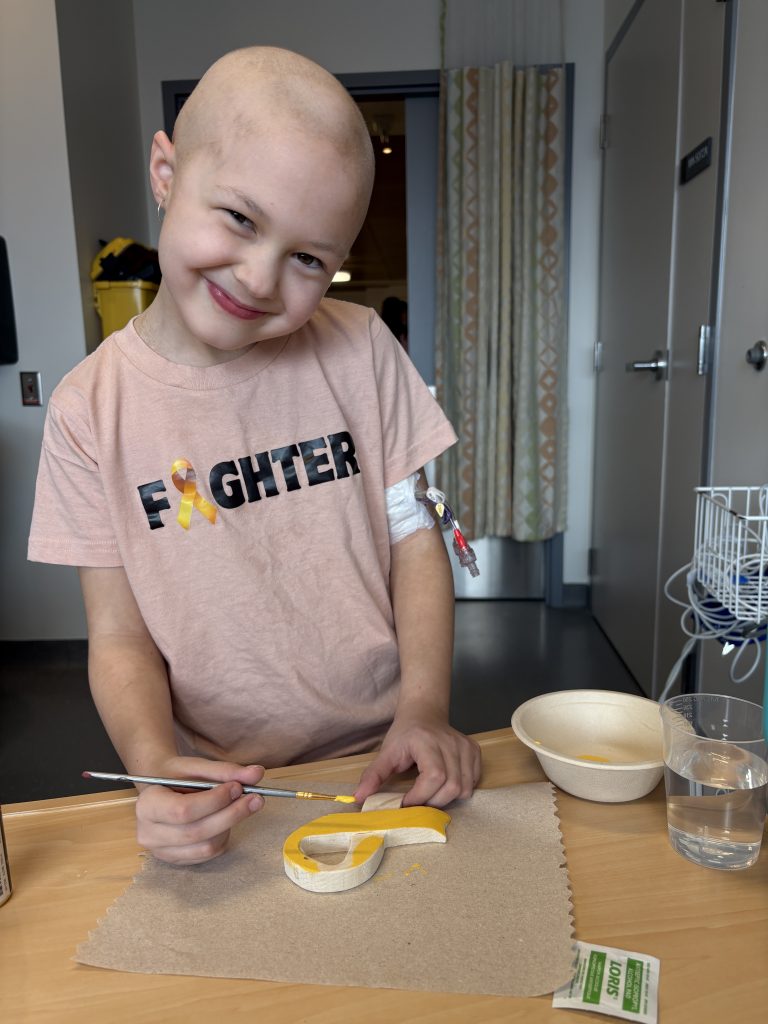 Abby painting in her hospital room.
