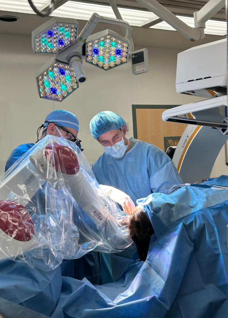 Neurosurgeons insert small electrodes into Cloé's brain using the ROSA surgical robot.