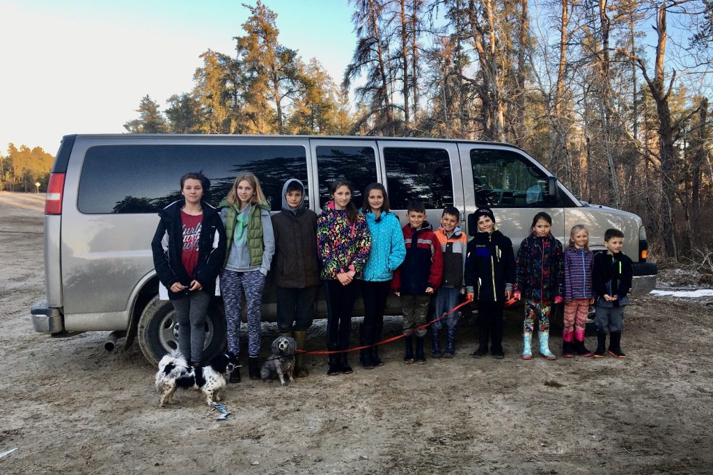 Fallon and her siblings in front of their van.