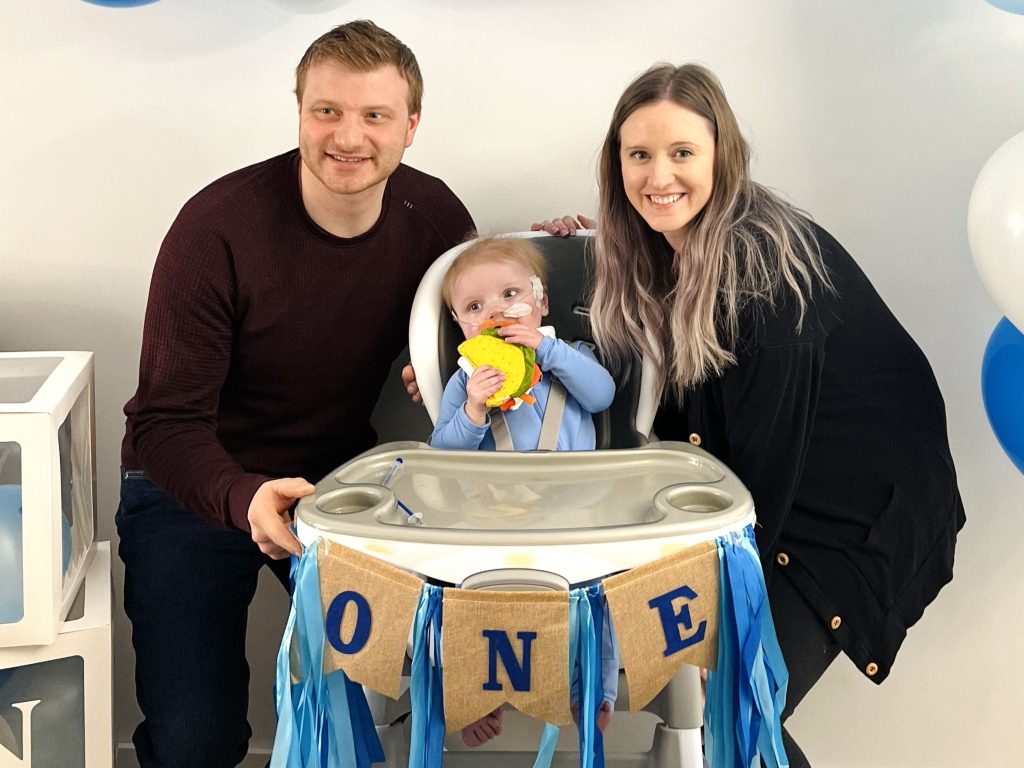 Paxton with his parents Mark and Kelsey on his first birthday.