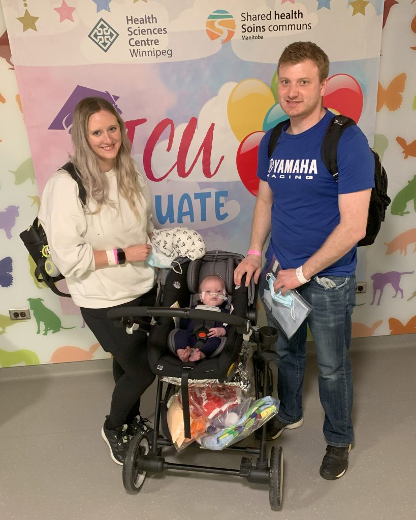 Kelsey and Mark leaving the NICU with Paxton in a stroller.